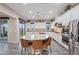 Stylish kitchen with a large island, white cabinets, stainless steel appliances, and modern pendant lighting at 342 Molinetto St, Las Vegas, NV 89138