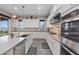 Well-appointed kitchen with a large island, custom white cabinets, and stainless steel appliances at 342 Molinetto St, Las Vegas, NV 89138