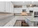 Modern kitchen featuring white cabinets, stainless steel appliances, and gray countertops at 342 Molinetto St, Las Vegas, NV 89138