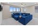 Bright living room with plush blue sectional sofa and cityscape views at 342 Molinetto St, Las Vegas, NV 89138