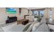 Cozy living room featuring a plush sectional sofa, decorative pillows, and seamless flow to the dining area at 342 Molinetto St, Las Vegas, NV 89138