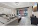 Inviting living room featuring a comfortable sectional sofa, stylish coffee table, and sliding door access to the patio at 342 Molinetto St, Las Vegas, NV 89138