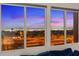 Living room with large windows offering views of the city skyline at 342 Molinetto St, Las Vegas, NV 89138