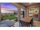 Covered outdoor patio with dining area and a lush, landscaped backyard at 342 Molinetto St, Las Vegas, NV 89138