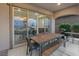 Covered patio with seating and a sliding glass door into the home at 342 Molinetto St, Las Vegas, NV 89138