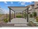 Pergola with a gravel base and stepping stone walkway leading to a small garden, creating a cozy backyard retreat at 342 Molinetto St, Las Vegas, NV 89138