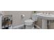 Powder room with modern fixtures including pedestal sink, toilet, and decorative open shelf at 342 Molinetto St, Las Vegas, NV 89138