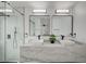 Bright bathroom featuring a marble countertop, dual sinks, modern fixtures, and a glass-enclosed shower at 345 Templeton Dr, Henderson, NV 89074