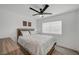 This bedroom features neutral decor, wood-look flooring, and a ceiling fan at 345 Templeton Dr, Henderson, NV 89074
