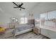 This bedroom features a large window, wood-look floors, and neutral decor at 345 Templeton Dr, Henderson, NV 89074