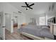 This bedroom features wood-look flooring, neutral decor, and a ceiling fan at 345 Templeton Dr, Henderson, NV 89074