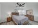 Well-lit bedroom with modern furniture, a ceiling fan, and a window offering natural light at 345 Templeton Dr, Henderson, NV 89074