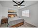 Cozy bedroom with wooden furniture, a ceiling fan, and a window providing natural light at 345 Templeton Dr, Henderson, NV 89074