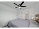 This bedroom features neutral gray bedding, a modern ceiling fan, and new paint at 345 Templeton Dr, Henderson, NV 89074