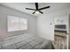 Comfortable bedroom featuring a ceiling fan, window, and a view into an adjacent bedroom at 345 Templeton Dr, Henderson, NV 89074