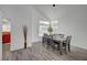 Inviting dining room with a modern table set, large window for natural light, and wood-look flooring at 345 Templeton Dr, Henderson, NV 89074