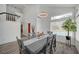 Elegant dining room with modern decor, a stylish light fixture, and a view to the outdoor area at 345 Templeton Dr, Henderson, NV 89074