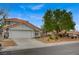Charming home with a two-car garage, landscaped front yard, and a classic southwestern-style roof at 345 Templeton Dr, Henderson, NV 89074