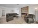 Cozy living room showcases a stone accent wall with modern fireplace, comfortable seating, and modern flooring at 345 Templeton Dr, Henderson, NV 89074