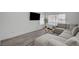 Spacious living room with a modern sectional sofa, stylish decor, and a wall-mounted television at 345 Templeton Dr, Henderson, NV 89074