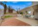 Enjoy outdoor living on this patio with brickwork, patio furniture, and backyard access at 345 Templeton Dr, Henderson, NV 89074