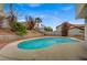 Relax in this backyard pool surrounded by palm trees and mature landscaping at 345 Templeton Dr, Henderson, NV 89074