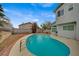 The backyard features a beautiful in-ground pool with desert landscaping at 345 Templeton Dr, Henderson, NV 89074
