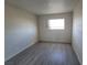 Bright bedroom featuring wood-look floors and a window for natural light at 3749 Ponderosa Ave, Las Vegas, NV 89115