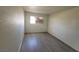 Cozy bedroom featuring neutral walls and wood-look flooring with a bright window at 3749 Ponderosa Ave, Las Vegas, NV 89115
