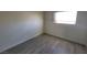 Cozy bedroom features wood-look flooring, and large window at 3749 Ponderosa Ave, Las Vegas, NV 89115