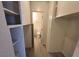Hallway showcasing storage shelves and access to bathroom with neutral finishes at 3749 Ponderosa Ave, Las Vegas, NV 89115
