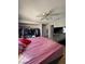 Bedroom with hardwood floors, a ceiling fan, closet and a bed with pink covers at 3813 Marshall Cir, Las Vegas, NV 89108