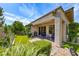 Charming backyard featuring a covered patio, lush greenery, and a serene outdoor living space at 4 Annadale Ct, Henderson, NV 89052