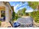 Inviting backyard featuring a patio with outdoor seating, a built-in pool, and manicured landscaping at 4 Annadale Ct, Henderson, NV 89052