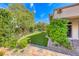 Manicured backyard features a beautiful lawn, lush landscaping, and a serene ambiance at 4 Annadale Ct, Henderson, NV 89052