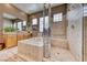 Bright bathroom with a soaking tub, shower with glass enclosure, and double sinks at 4 Annadale Ct, Henderson, NV 89052