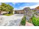 Lovely home exterior showcasing lush landscaping, a wide driveway, and colorful blooming bushes at 4 Annadale Ct, Henderson, NV 89052