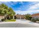 Charming single-story home featuring a well-manicured lawn, mature trees, and a two-car garage at 4 Annadale Ct, Henderson, NV 89052