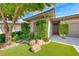 Inviting front entrance with beautiful landscaping, rock features, and a well-maintained lawn at 4 Annadale Ct, Henderson, NV 89052