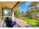 Relaxing covered patio with comfortable seating and views of the beautifully landscaped backyard at 4 Annadale Ct, Henderson, NV 89052