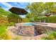 Beautifully landscaped pool with waterfall feature, creating a backyard oasis at 4 Annadale Ct, Henderson, NV 89052