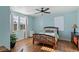 Bedroom featuring wooden floors, a ceiling fan, and bright windows at 4350 Westbury Square St # 3, North Las Vegas, NV 89032