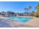 Community swimming pool surrounded by palm trees, lounge chairs, and covered seating, ideal for relaxation at 4350 Westbury Square St # 3, North Las Vegas, NV 89032