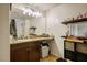 Bathroom vanity with granite countertop, dark wood cabinets, and decorative mirror at 4610 Lime Straight Dr, Las Vegas, NV 89115