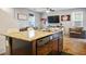 Open kitchen with a granite-topped island, stainless steel appliances, and easy access to the living area for seamless entertaining at 4610 Lime Straight Dr, Las Vegas, NV 89115