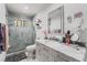 This updated bathroom features marble walls, glass shower, and modern vanity at 4870 E Colorado Ave, Las Vegas, NV 89104