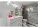 Modern bathroom with a white vanity, a large mirror, and a tiled walk-in shower at 4870 E Colorado Ave, Las Vegas, NV 89104