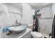 Bathroom with marble tiled shower, pebble floor, and unique glass vessel sink on a modern vanity at 4870 E Colorado Ave, Las Vegas, NV 89104