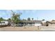 Charming single-story home featuring a gray exterior, a well-maintained yard, and an attached two-car garage at 4870 E Colorado Ave, Las Vegas, NV 89104
