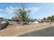Exterior view of a home with desert landscaping and a well-maintained lawn at 4870 E Colorado Ave, Las Vegas, NV 89104